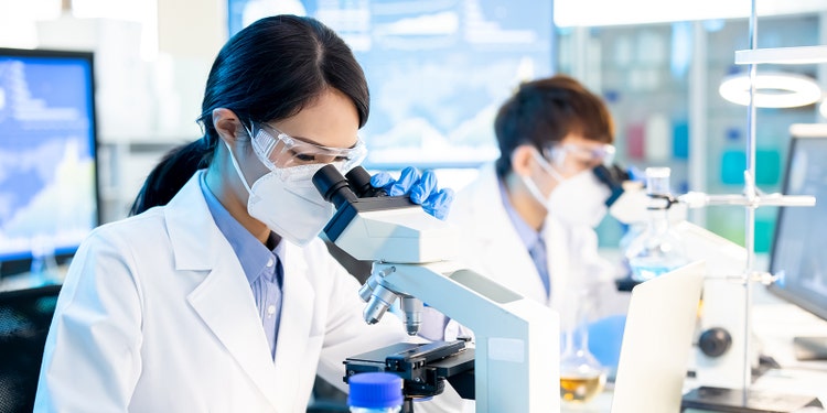 asian scientist female use microscope in the laboratory with her panter